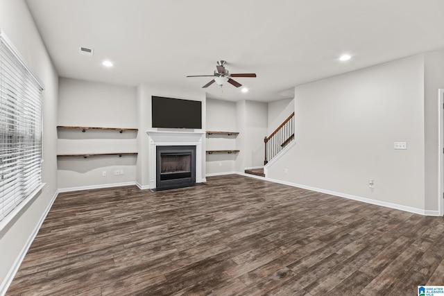 unfurnished living room with ceiling fan and dark hardwood / wood-style flooring