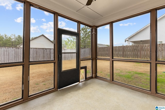 unfurnished sunroom with ceiling fan