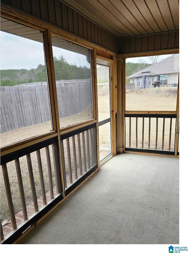 unfurnished sunroom featuring wooden ceiling