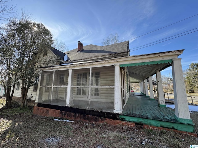 view of property exterior featuring a sunroom