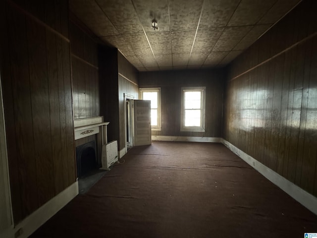 spare room featuring a tiled fireplace