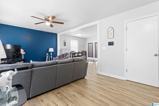 living room featuring ceiling fan and light wood-type flooring