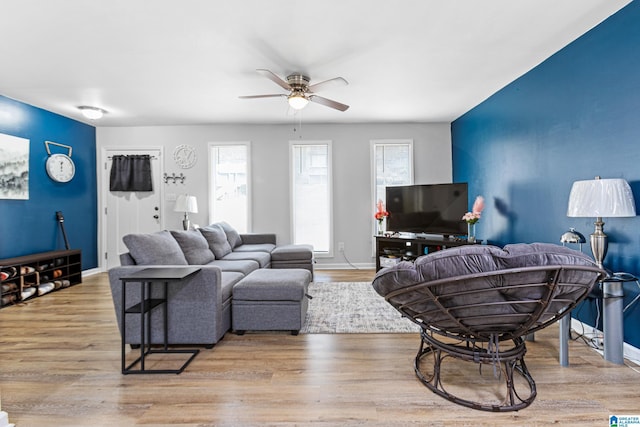 living room featuring ceiling fan and light hardwood / wood-style floors