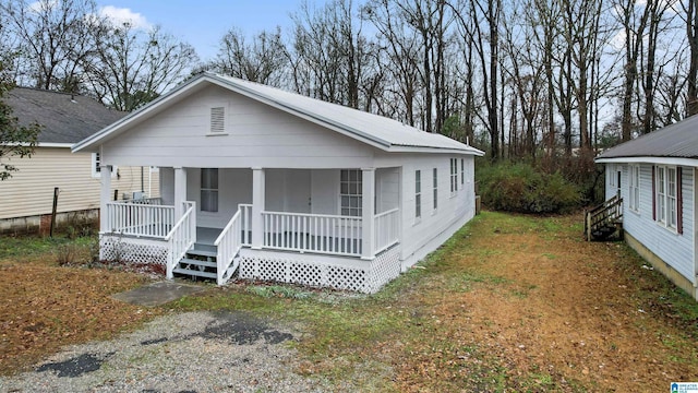 bungalow-style house with covered porch and a front yard