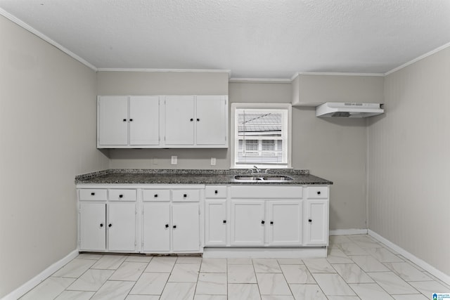 kitchen featuring sink, white cabinets, dark stone counters, ornamental molding, and a textured ceiling