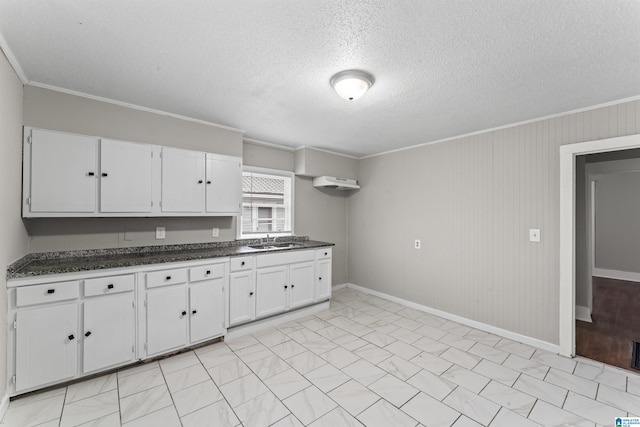 kitchen with white cabinetry, sink, a textured ceiling, and crown molding