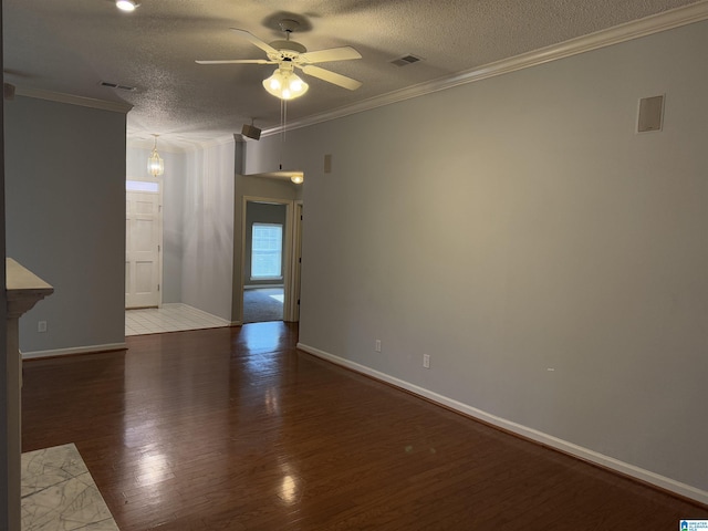 empty room featuring ornamental molding, hardwood / wood-style floors, ceiling fan, and a textured ceiling