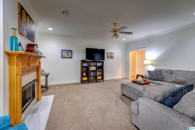 carpeted living room with a premium fireplace, crown molding, and ceiling fan