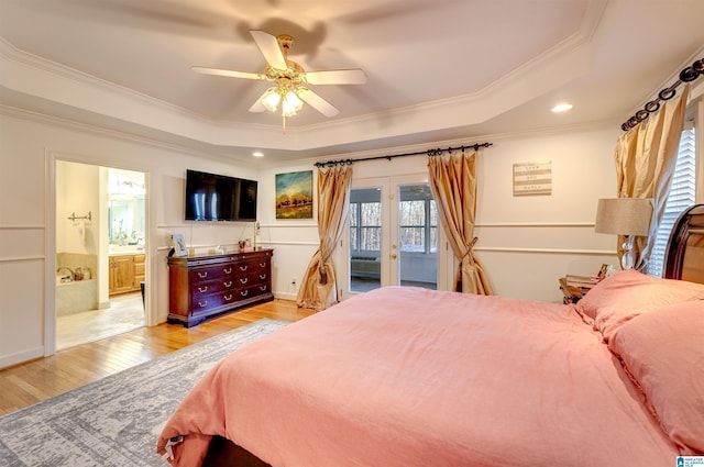 bedroom featuring crown molding, access to exterior, a tray ceiling, and light hardwood / wood-style floors