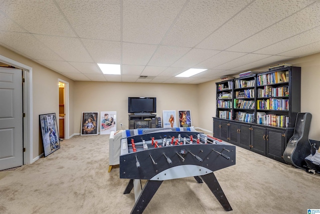 rec room with carpet and a drop ceiling