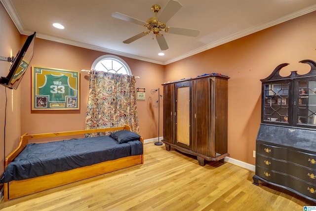 bedroom with crown molding, ceiling fan, and light hardwood / wood-style floors