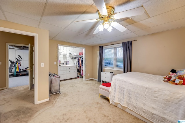 bedroom featuring ceiling fan, a paneled ceiling, and carpet flooring