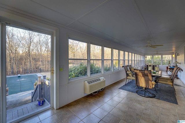 sunroom / solarium featuring a wall mounted air conditioner and ceiling fan