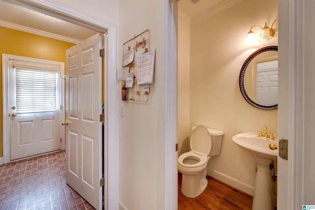 bathroom featuring ornamental molding and toilet