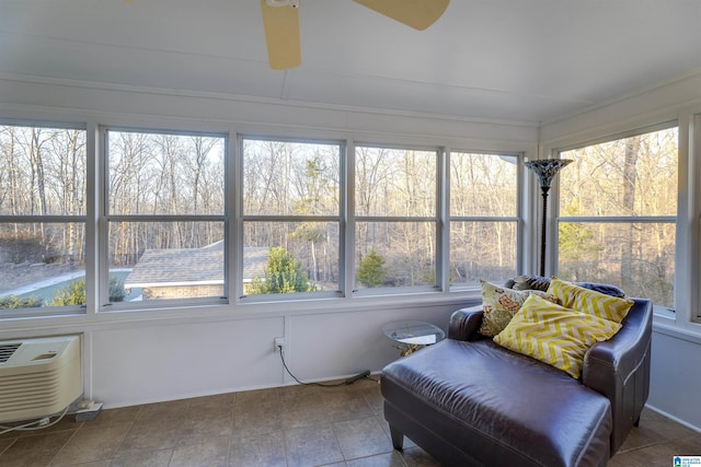 sunroom featuring an AC wall unit and a wealth of natural light