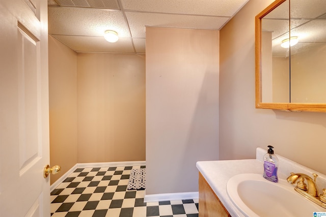 bathroom featuring vanity and a drop ceiling