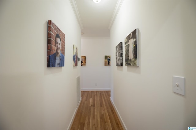 hallway with ornamental molding and wood-type flooring