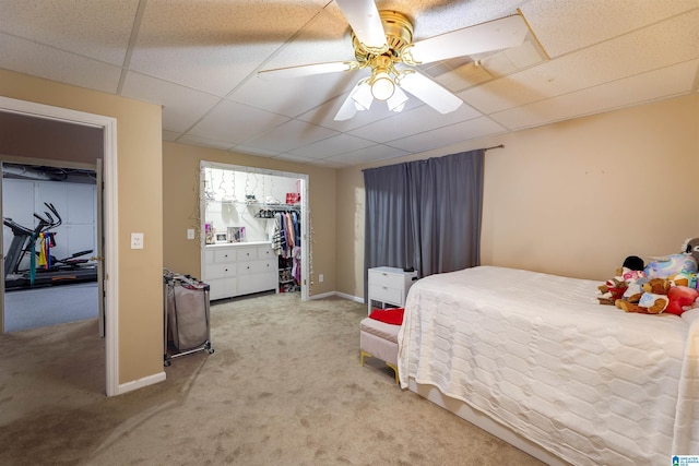 bedroom with carpet, a drop ceiling, and ceiling fan