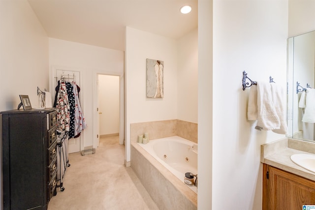 bathroom with a relaxing tiled tub and vanity