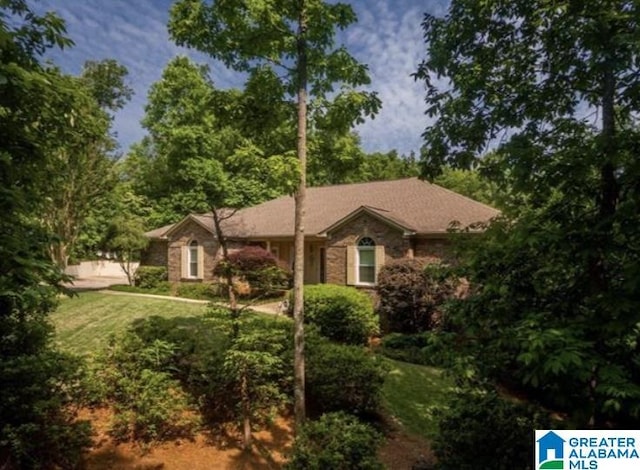 ranch-style house with a front lawn