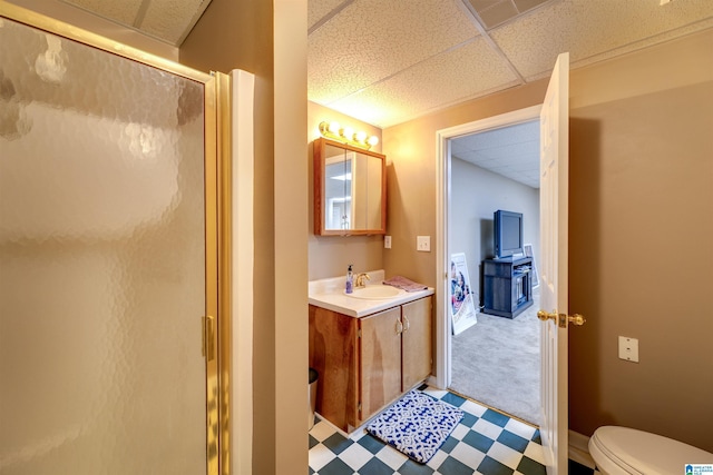 bathroom with vanity, a paneled ceiling, and a shower with door