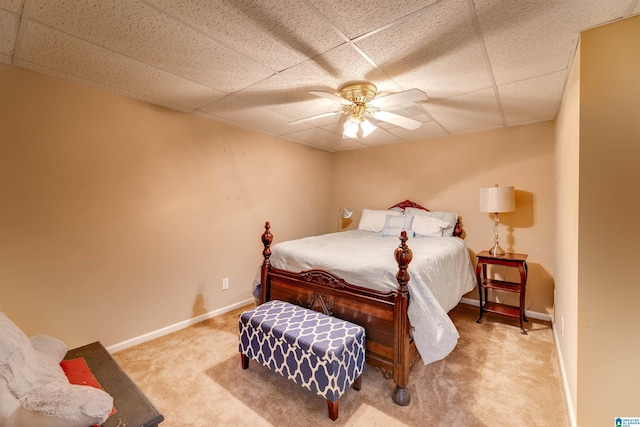 bedroom featuring a drop ceiling, ceiling fan, and carpet flooring