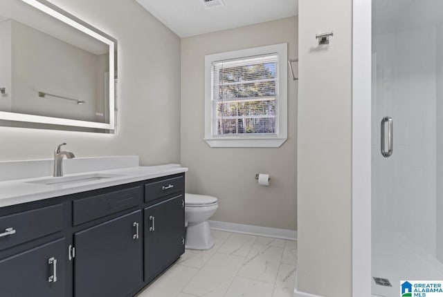 bathroom with vanity, toilet, and a shower with shower door