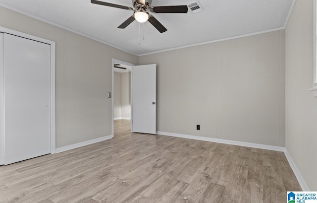 unfurnished bedroom with crown molding, ceiling fan, and light wood-type flooring