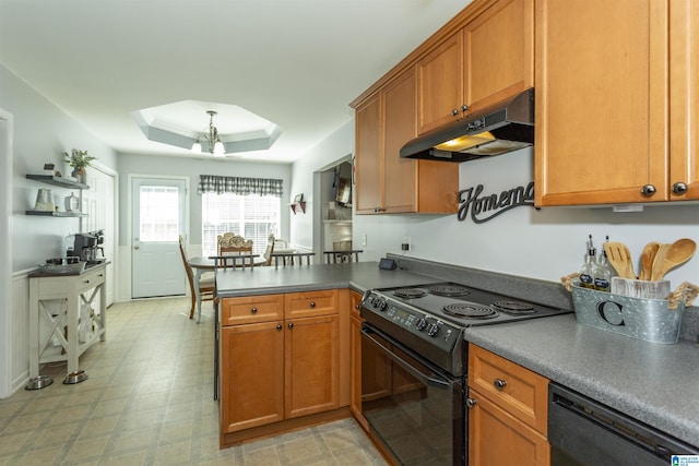 kitchen featuring an inviting chandelier, a tray ceiling, black appliances, and kitchen peninsula