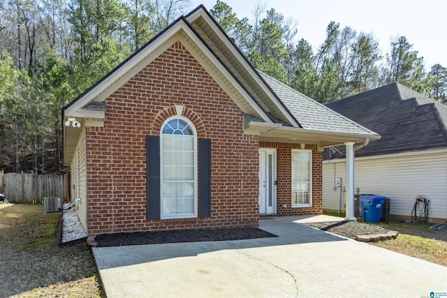 view of front of house with cooling unit and a patio area