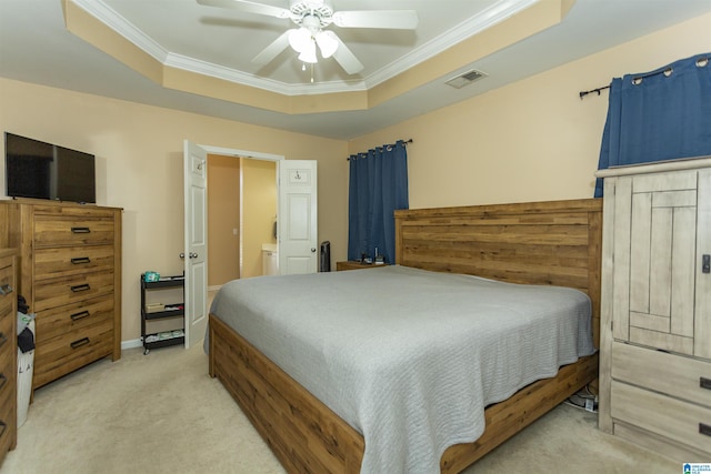 carpeted bedroom with crown molding, ceiling fan, and a tray ceiling