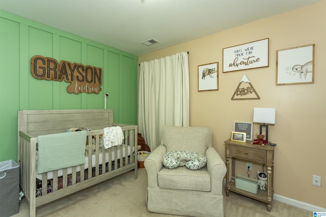 carpeted bedroom with a nursery area