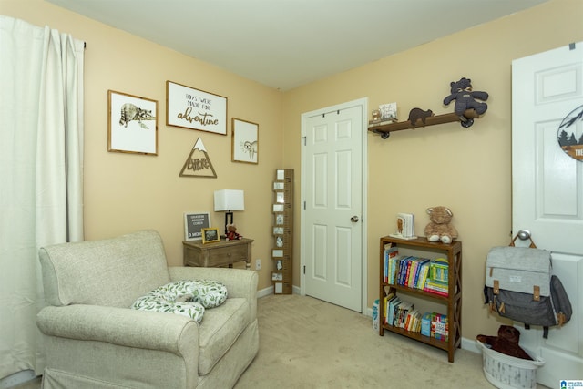 sitting room featuring light colored carpet