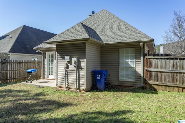 back of property with a lawn