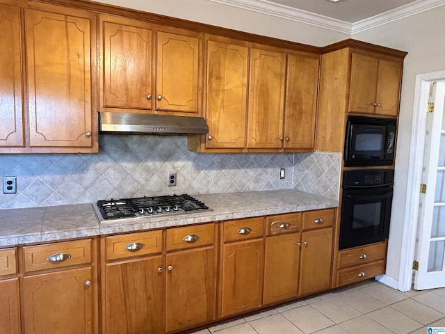 kitchen featuring crown molding, light tile patterned flooring, decorative backsplash, and black appliances