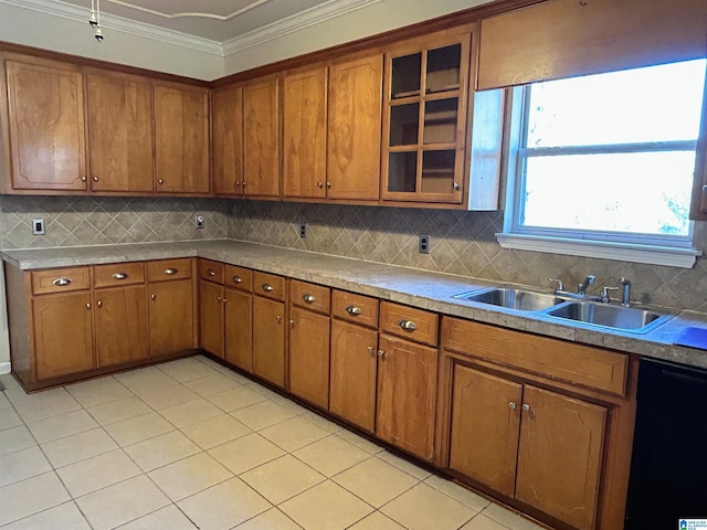 kitchen featuring sink, crown molding, decorative backsplash, and black dishwasher