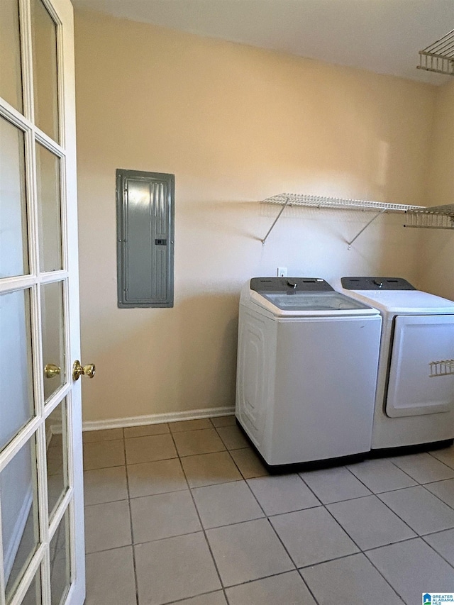 laundry room featuring independent washer and dryer, electric panel, and light tile patterned floors