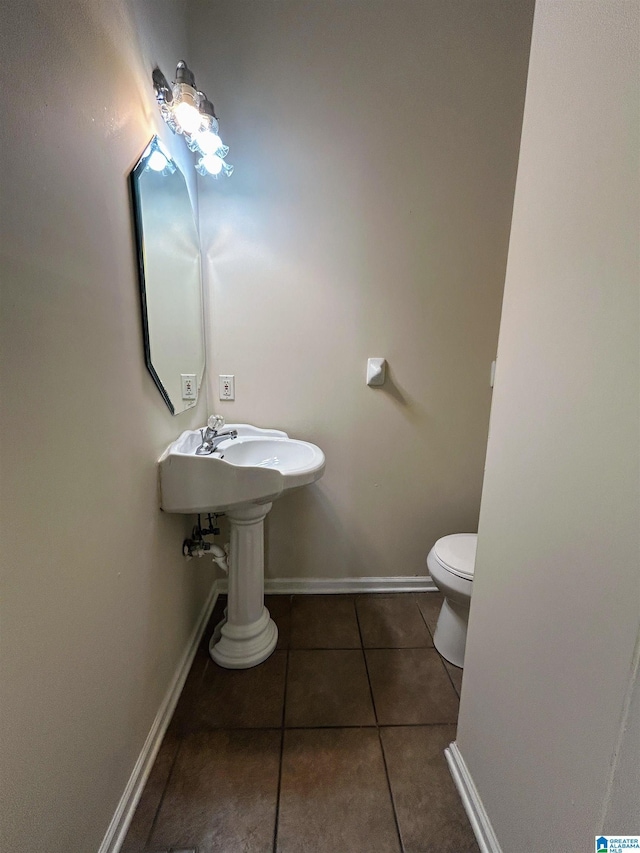 bathroom with tile patterned floors and toilet