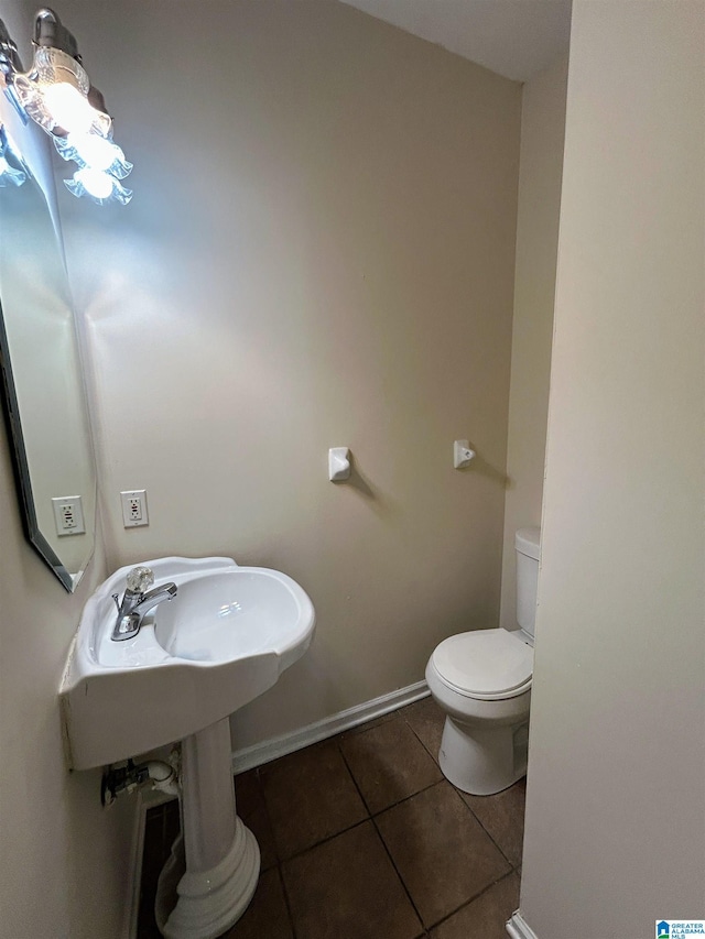 bathroom with tile patterned flooring and toilet