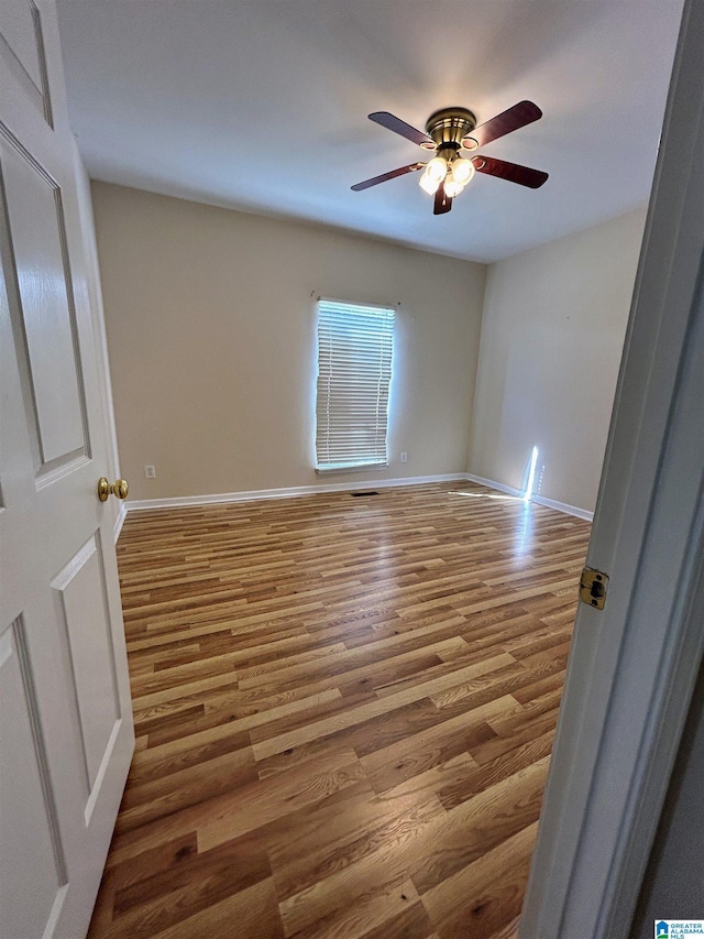 empty room featuring ceiling fan and wood-type flooring