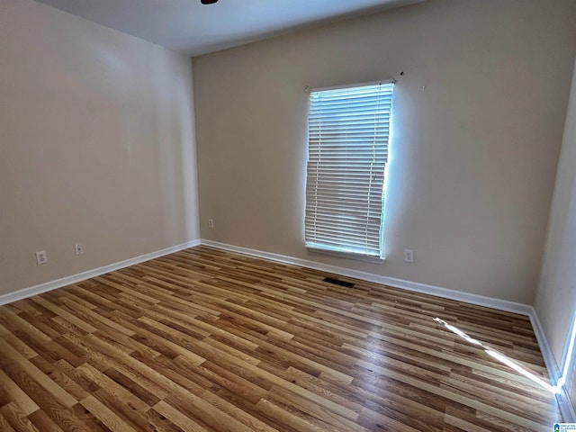 spare room with wood-type flooring