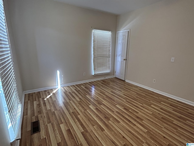 unfurnished room with wood-type flooring