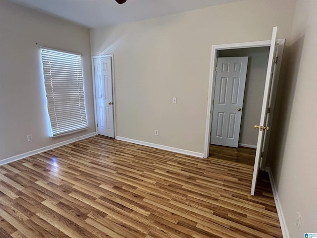 unfurnished room featuring ceiling fan and hardwood / wood-style floors