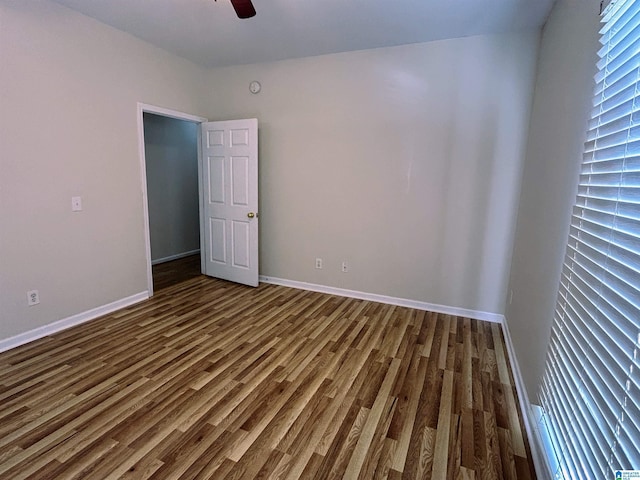 unfurnished bedroom with ceiling fan and dark hardwood / wood-style floors