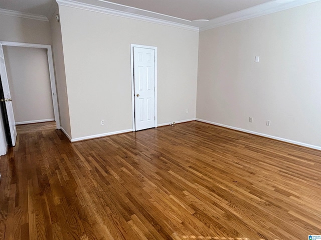 spare room featuring hardwood / wood-style floors and ornamental molding