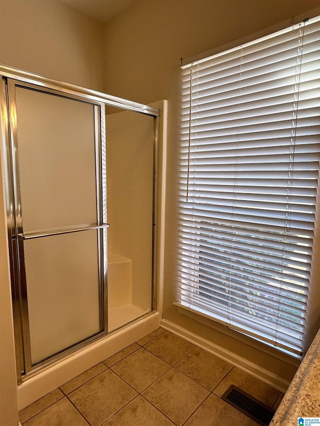 bathroom featuring walk in shower and tile patterned floors