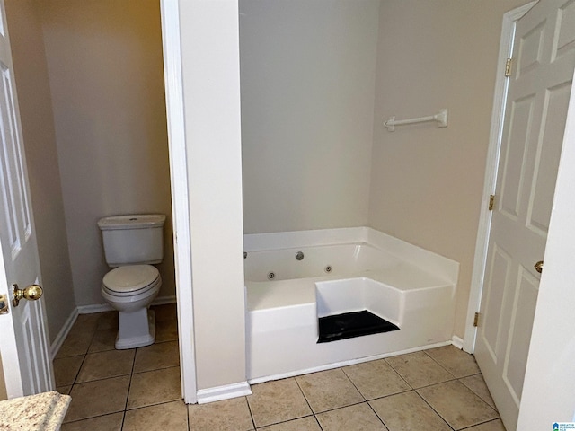 bathroom with tile patterned flooring, a bathtub, and toilet