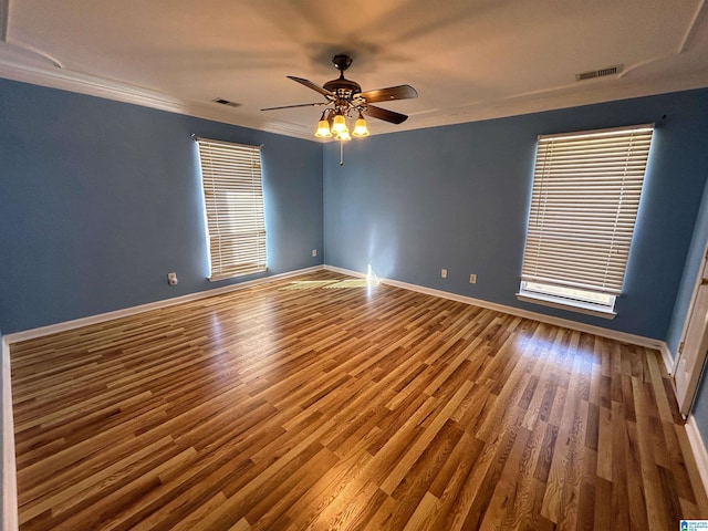 unfurnished room featuring wood-type flooring, ornamental molding, and ceiling fan