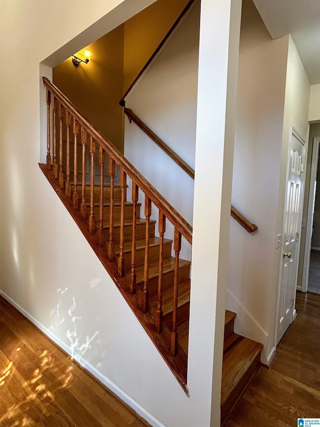 stairs with hardwood / wood-style floors