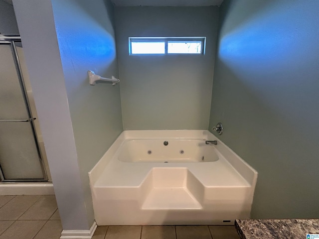 bathroom featuring a washtub and tile patterned floors